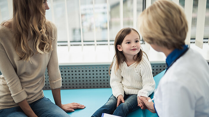 Medical consultation of little girl by doctor