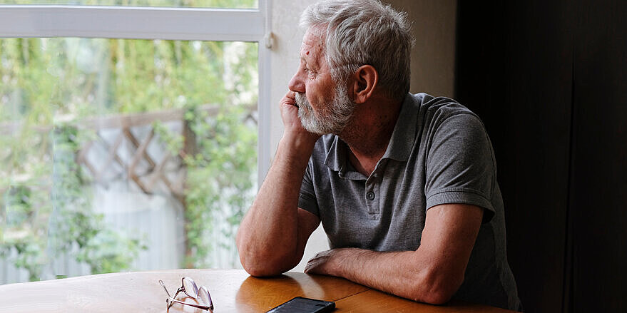 Senior retired man sitting at home alone while quarantine