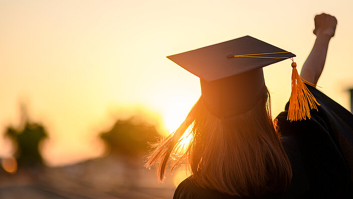 Graduates wear a black dress, black hat at the university level.